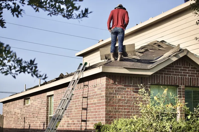 Professional roofer working on a residential roof in Brookside Village
